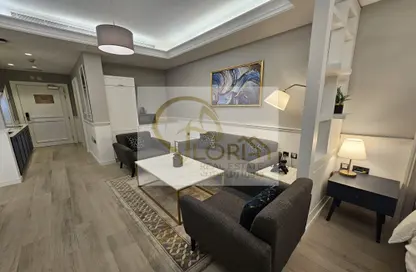 Living Room image for: Apartment - 1 Bathroom for rent in Bin Al Sheikh Towers - Al Mirqab Al Jadeed - Doha, Image 1