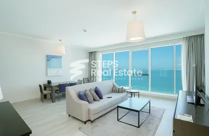 Living / Dining Room image for: Apartment - 1 Bedroom - 2 Bathrooms for sale in West Bay Tower - West Bay - West Bay - Doha, Image 1