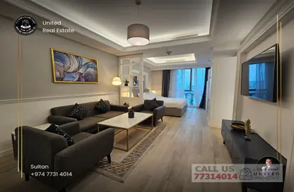 Living Room image for: Apartment - 1 Bedroom - 1 Bathroom for sale in Bin Al Sheikh Towers - Al Mirqab Al Jadeed - Doha, Image 1