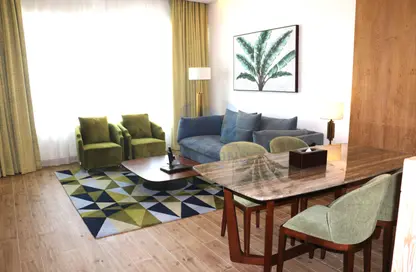 Living / Dining Room image for: Apartment - 1 Bedroom - 2 Bathrooms for rent in City Center Towers - West Bay - Doha, Image 1